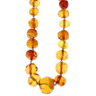 A natural amber necklace. The forty-seven beads of roughly circular shape, measuring 2.7 to 1cms. On