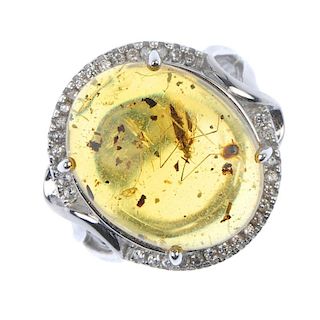 A natural Burmese amber ring with bug inclusion. The oval-shape amber cabochon measuring 1.6cms, wit
