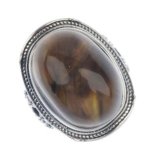 A root amber cabochon ring. The oval-shape amber cabochon measuring 2cms in length, with rope-twist