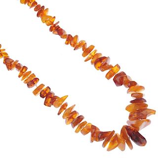 A natural and modified amber bead necklace. Designed as a single-strand of graduated freeform natura