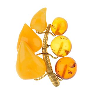 A natural amber ring, a polyburn ring and a natural and modified amber brooch. The brooch of foliate