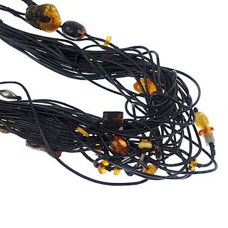 Five corded amber necklaces and a bracelet. All designed as multiple black cords with rough amber pi