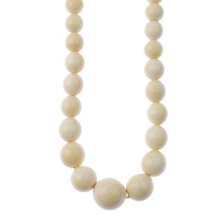 An early 20th century ivory bead necklace. Designed as graduated spherical beads measuring 5 to 15mm