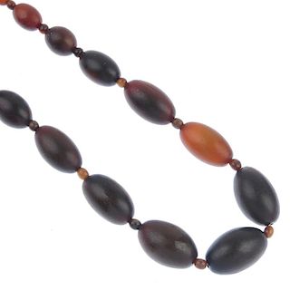 A horn bead necklace. Comprising twenty-seven graduated oval horn beads measuring 3.7 to 1.7cms, eac