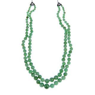 A jade bead necklace. Comprising two rows of graduated spherical beads measuring 1 to 0.4cms to the