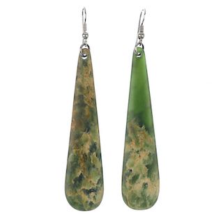 A pair of New Zealand jade ear pendants. Both of elongated pear-shape, to the ear hook. Lengths 8.2