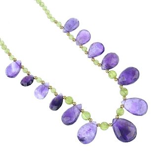 An amethyst and peridot necklace, bracelet and ear pendant set. The necklace designed as a series of