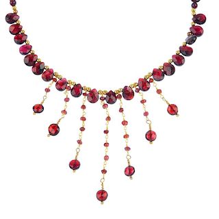 A garnet necklace. The circular and pear-shape garnet beads with gold-tone bead accents, to the garn