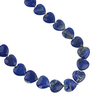 A lapis lazuli necklace and earrings. The necklace designed as a series of heart-shape lapis lazuli