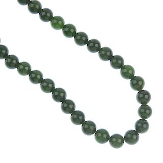 A pair of Mexican shell earrings and a nephrite jade bead necklace. The necklace comprising a series