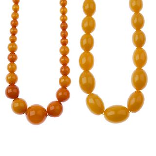 Two plastic bead necklaces. The first designed as a single row of yellow, graduated oval-shape plast
