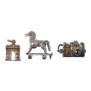 A selection of charms. To include a partial bracelet suspending four charms, a Trojan horse and a To