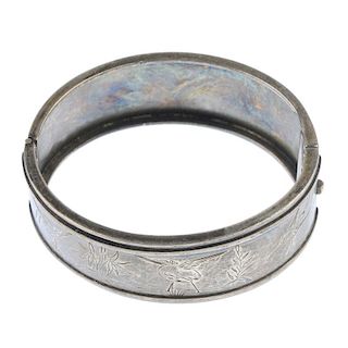 A hinged bangle. Engraved to depict three herons by water, with a raised bar border and plain revers