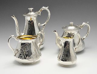 A Victorian silver four piece tea service of tapering bellied form and engraved with Anthemion style