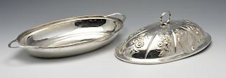A George III silver entree dish and cover, the oval form with reeded rim and twin handles and later