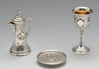 A Victorian silver cased Communion set, comprising a chalice, flagon and paten, each decorated with