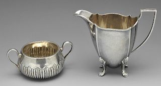 A late Victorian silver sugar bowl, the circular body part fluted with foliate accents and twin hand