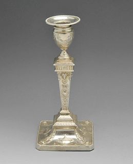 An Edwardian silver mounted candlestick of Neoclassical style, the urn shaped socket raised upon tap