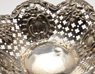 A late Victorian trinket dish of oval pierced and pressed form, hallmarked Birmingham 1898. Together
