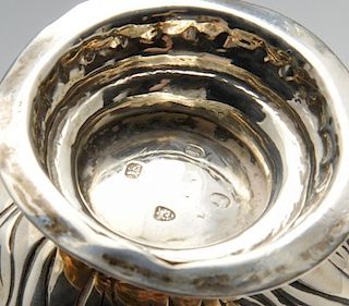 A George III silver cream jug, the bellied form with oblique and floral embossing and sparrow beak,
