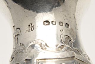 A mid-Victorian silver pepper pot with floral embossed decoration and engraved family crest, hallmar