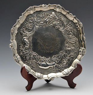 A suite of George II matched salvers, comprising a similar pair and third larger example, each of ci