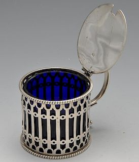 A Victorian silver drum mustard pot of pierced openwork form and blue glass liner. Hallmarked Elking