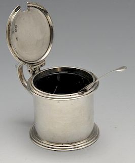 A Victorian silver drum mustard pot, the plain cylindrical form with crested hinged cover, scroll th