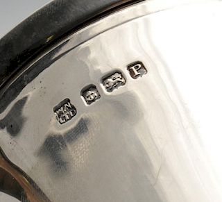 An Art Deco silver mug, of slight tapered form having accented handle raised upon a stepped foot. Ha