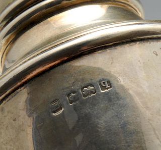 An early twentieth century silver caster of urn form, hallmarked Birmingham 1915, height measuring 6
