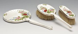 A 1960's cased silver mounted three piece dressing table set, comprising hand mirror hair brush and