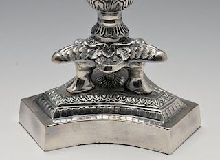 A pair of modern silver plated candelabra of Empire style, the tri-form base rising to the foliate m