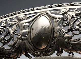 A German pierced bread basket of quatrefoil outline, the wide border decorated with semi-naked femal