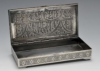 A Middle Eastern box of rectangular form, ornately decorated throughout with stylised floral and fol