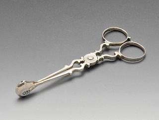 A pair of George III silver scissor action sugar tongs with scrolling body. Lion passant only visibl