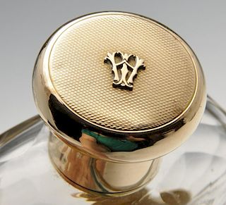 A 1920's 9ct gold mounted hip flask, the glass body with faceted shoulders, detachable cup and monog