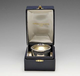 A modern silver musical jewellery or trinket box, the cylindrical with silver-gilt engine-turned hin