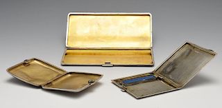 Three early twentieth century silver cigarette cases, comprising a large rectangular example having