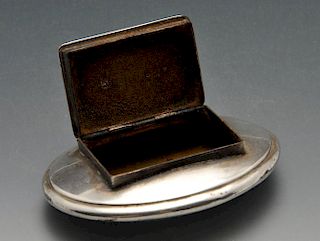 A George III silver snuff box of oval form with oblong hinged opening and applied vacant cartouche.