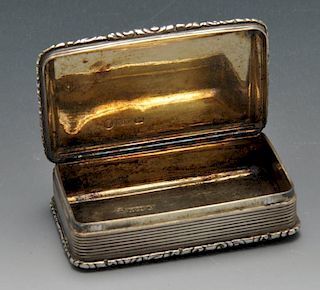 An early Victorian silver snuff box, the rounded rectangular form with floral scroll borders enclosi