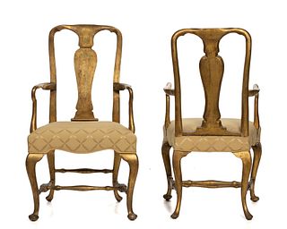 A pair of English Queen Anne carved giltwood armchairs