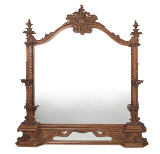 A carved wood wall mirror