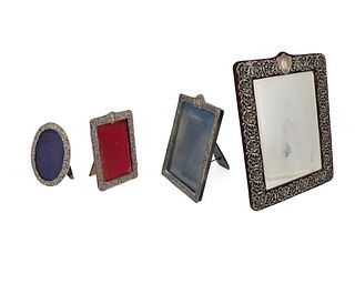 A group of silver table-top picture frames and mirror