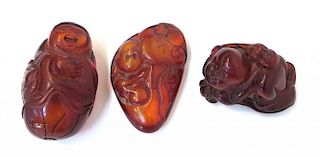 Three Amber Like Carvings