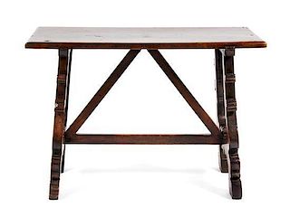 A Spanish Baroque Style Walnut Trestle Table Height 31 1/2 x width 45 1/2 x depth 22 1/2 inches.