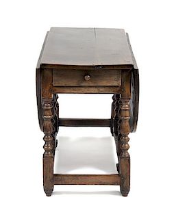 An English Oak Gate Leg Table Height 29 1/2 x width 52 x depth 21 inches (closed).
