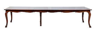 A Louis XV Provincial Style Mahogany Banquet Table the rectangular top with shaped ends, resting on cabriole legs terminating in