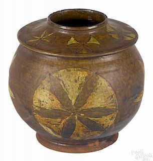 Pennsylvania redware jar, ca. 1830, with incised yellow slip star decoration, 7 1/2'' h.