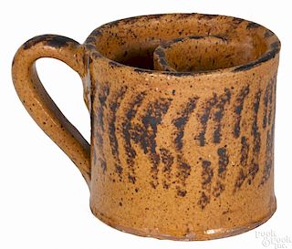 Pennsylvania redware shaving mug, 19th c., with manganese striped decoration, 3 1/2'' h.