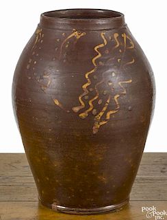 Pennsylvania redware jar, early 19th c., with slip decorated tulip with dot accents, 10'' h.